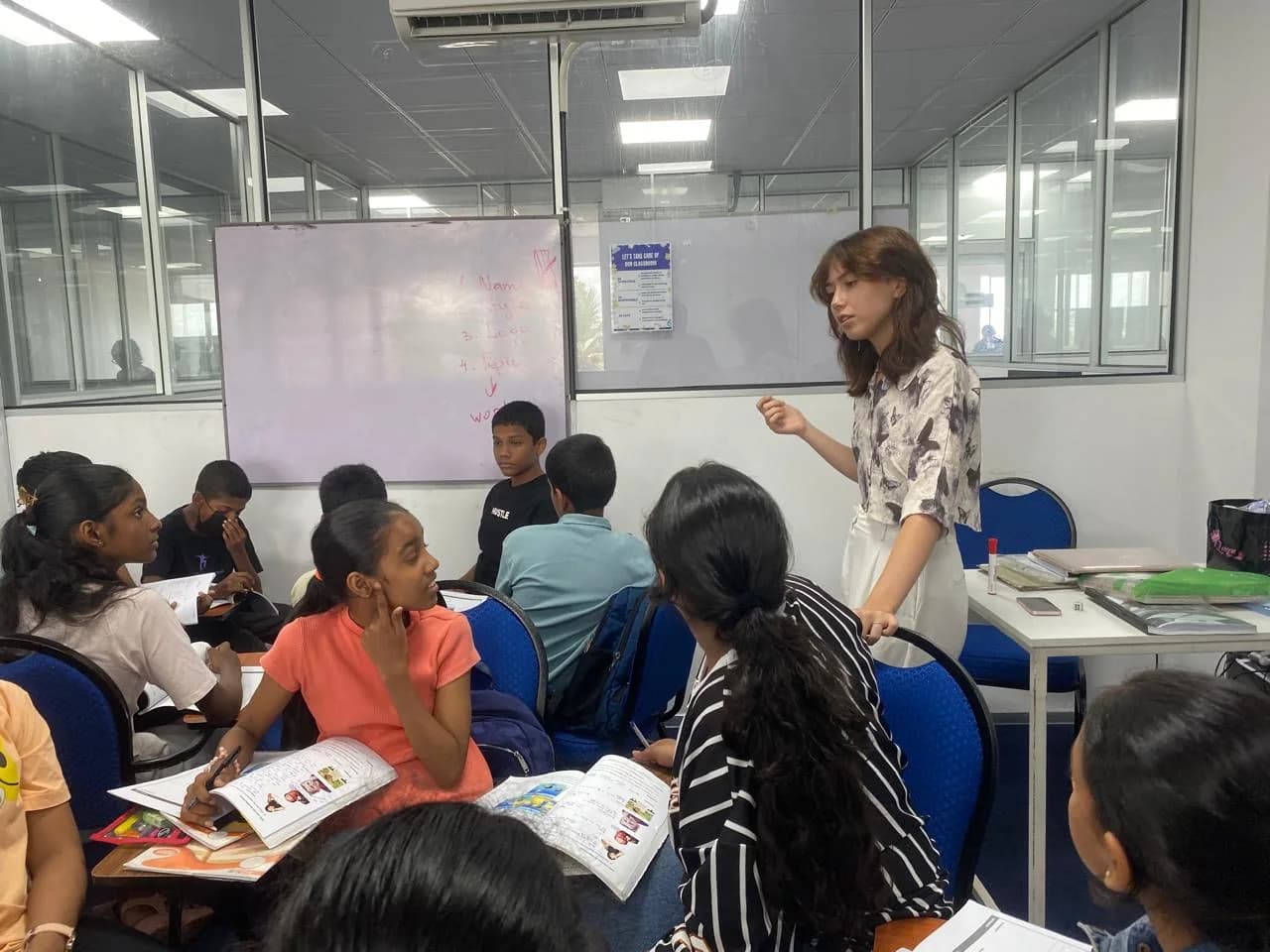 ESOL College teacher engaging with students in an interactive English lesson